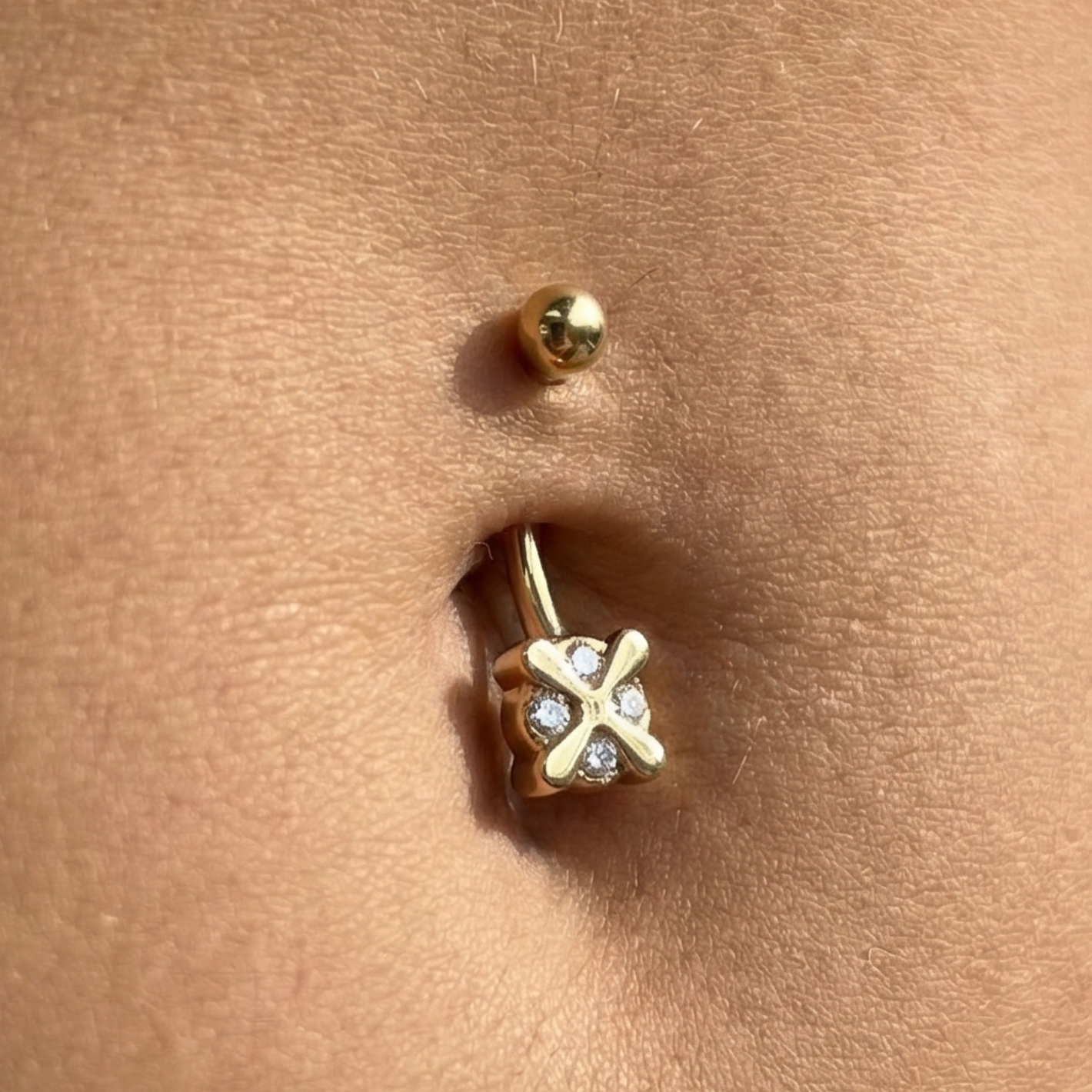 14K gold iron cross belly ring with clear gems shown worn on navel. Secure fit and elegant sparkle for everyday or special occasions.