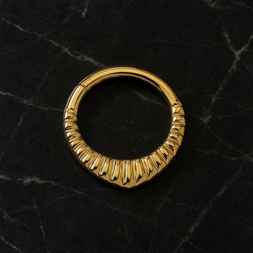 Top view of G23 Titanium Carved Teardrop Clicker in gold