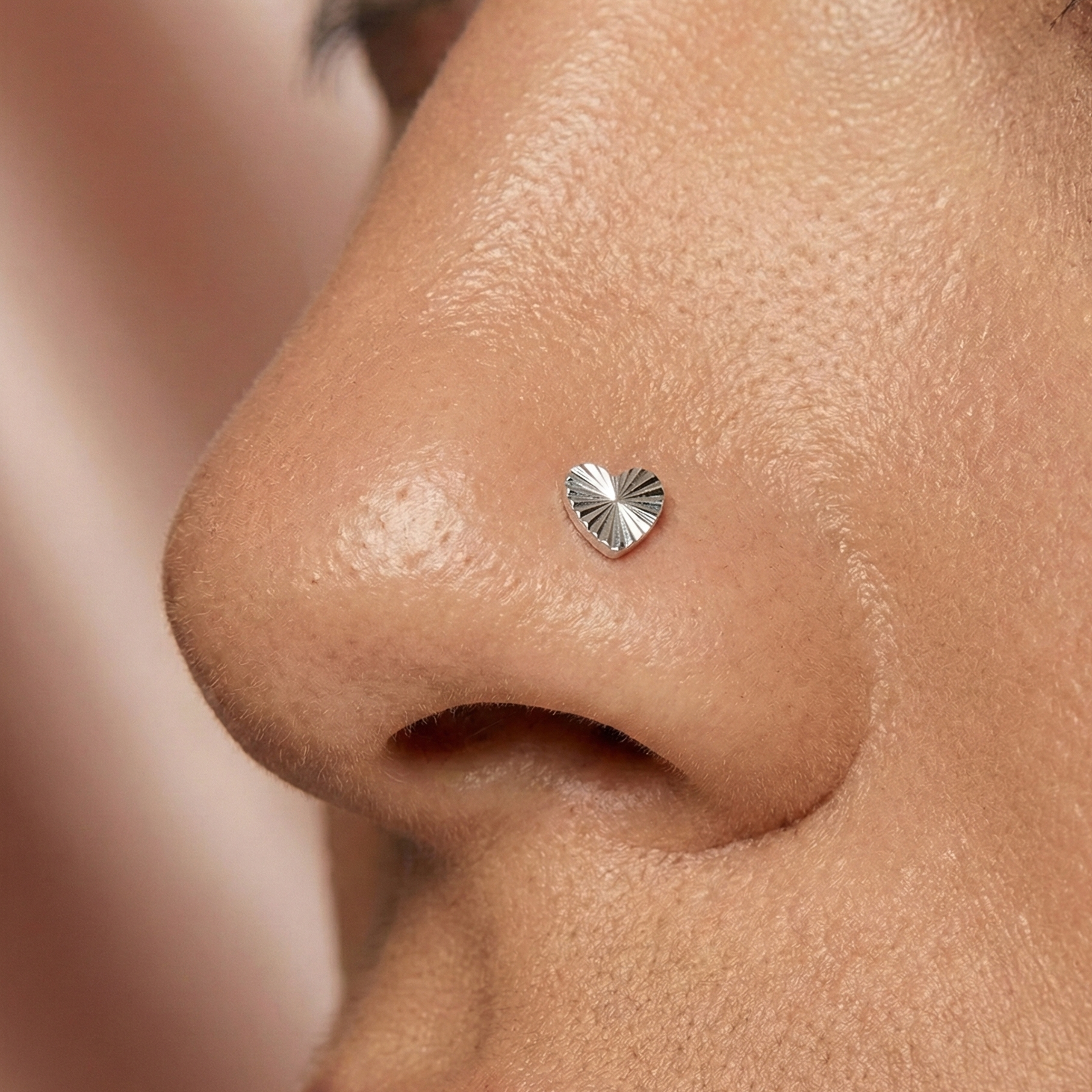 G23 Titanium Radiant Heart Threadless Nose Screw worn on nose, showcasing its elegant heart shape and secure fit for daily wear.