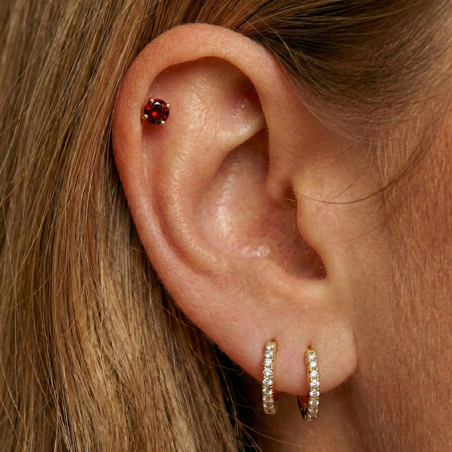 Minimal 14K Gold Garnet Natural Stone Flatback Stud styled on a helix piercing, paired with gold hoop earrings for a refined ear stack look.