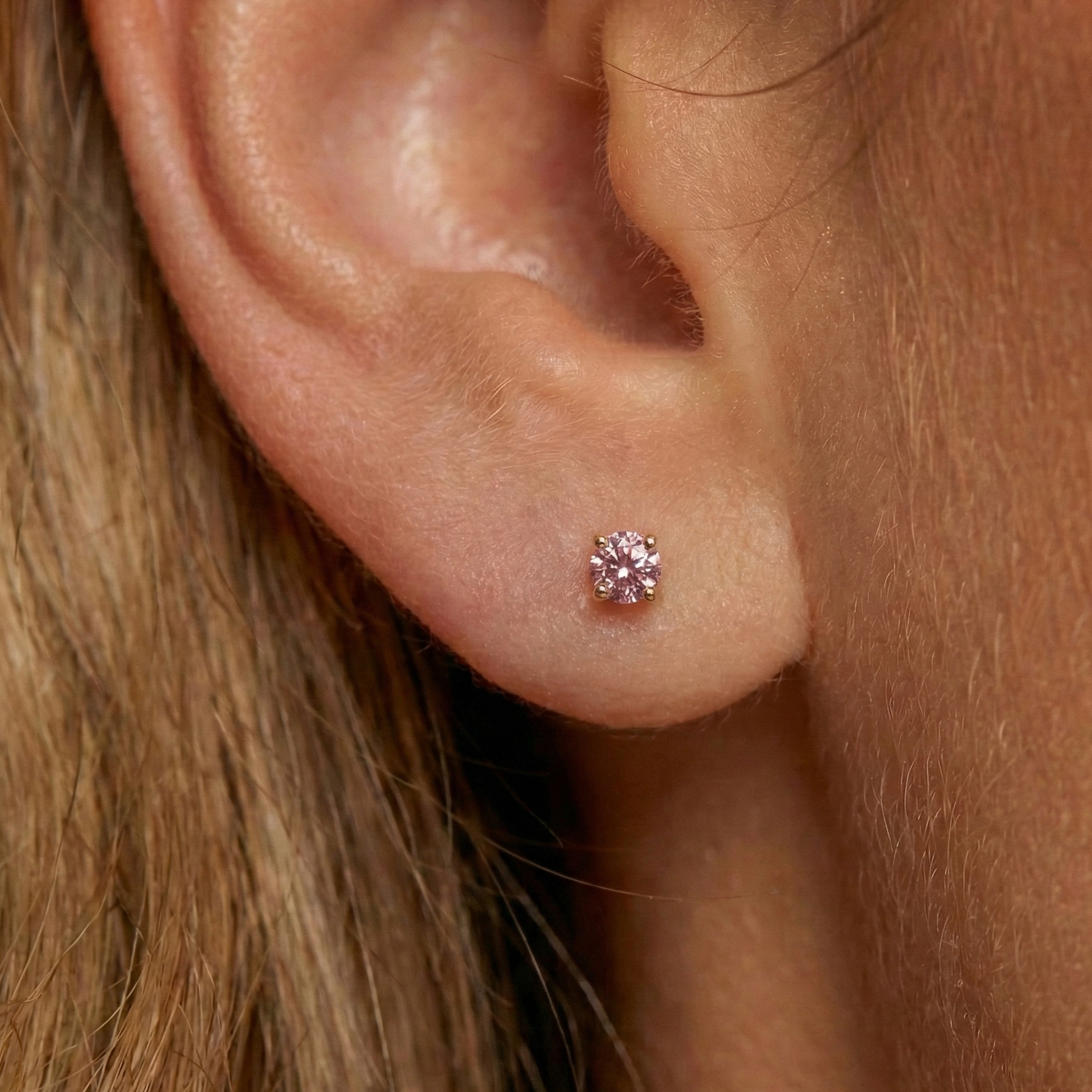 Classic 14K Gold Pink Lab Grown Diamond Internal Thread Stud styled on an earlobe, showcasing its delicate pink sparkle and secure flatback fit.