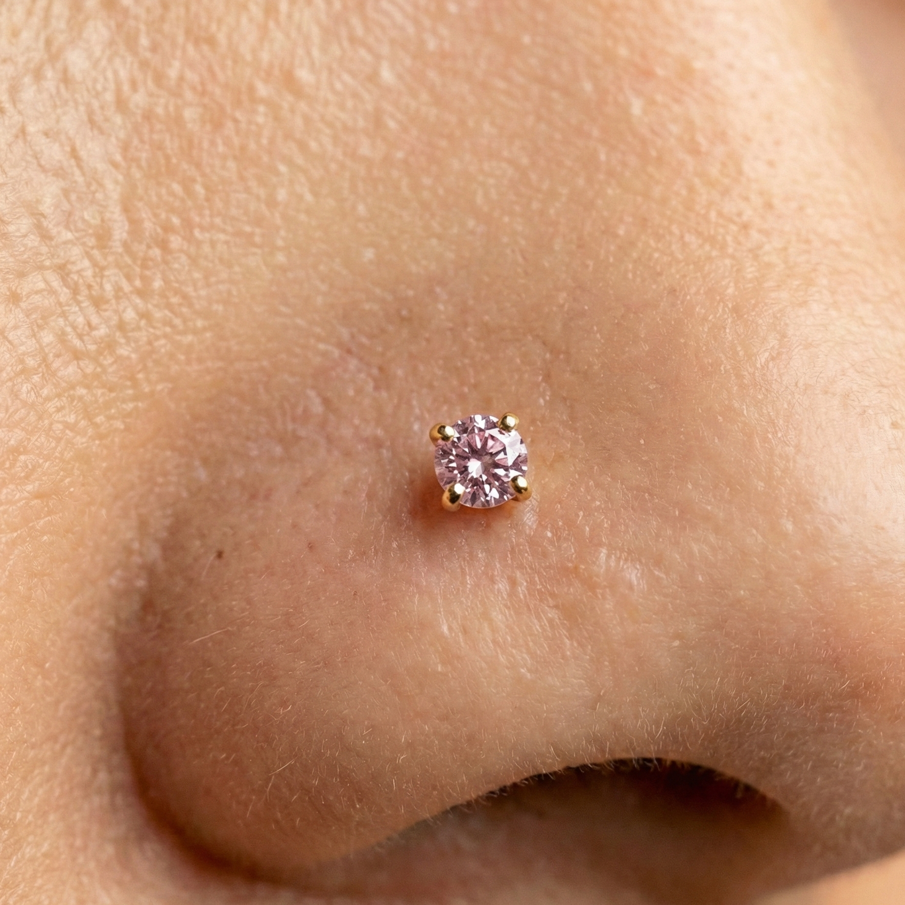 9K Gold Amethyst Natural Stone L-Bend Nose Stud worn on nose, showcasing the elegant pink amethyst stone in a secure claw setting.