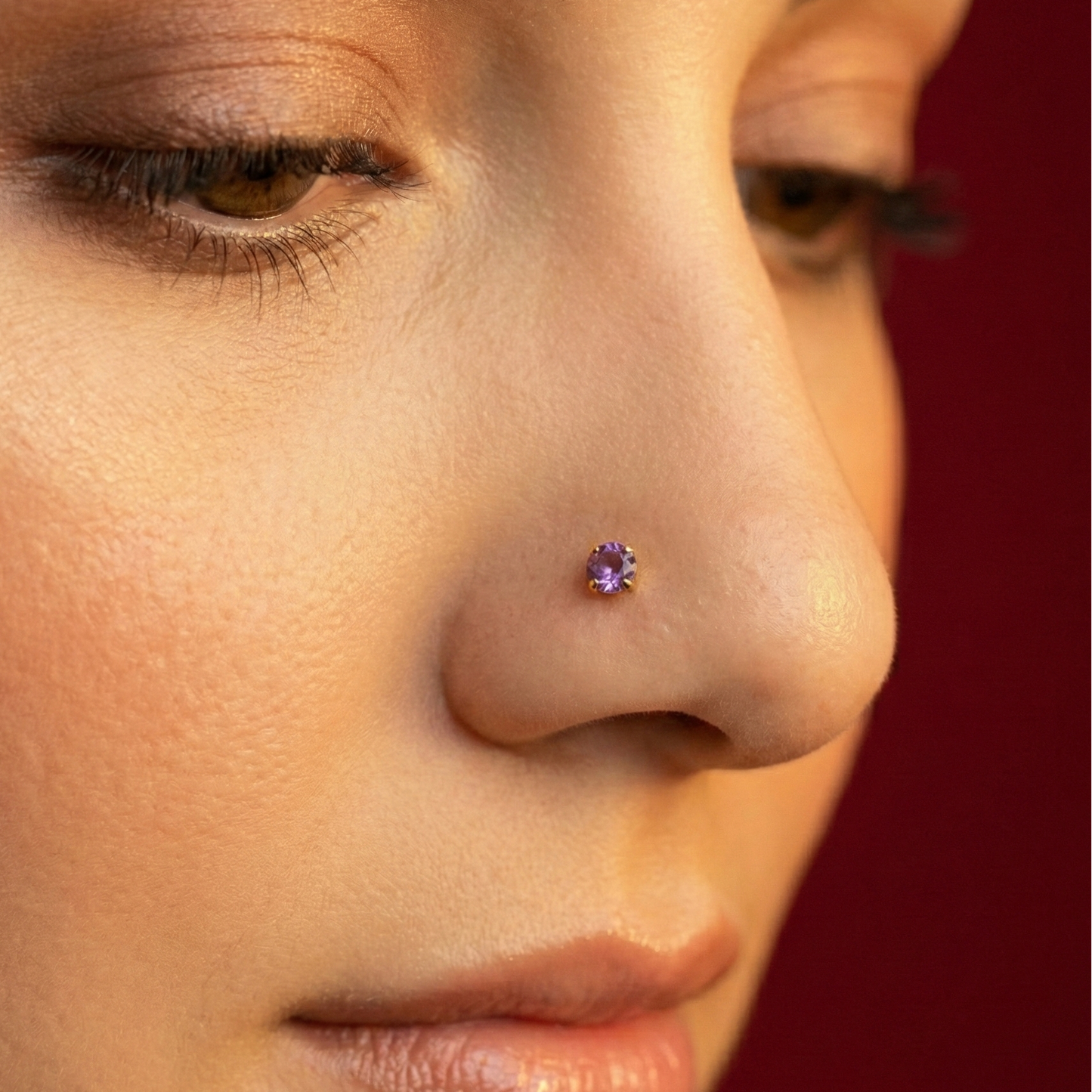 Model wearing Classic 14K Gold Amethyst Natural Stone Nose Stud, showcasing the elegant claw-set amethyst on the nostril for a refined look.
