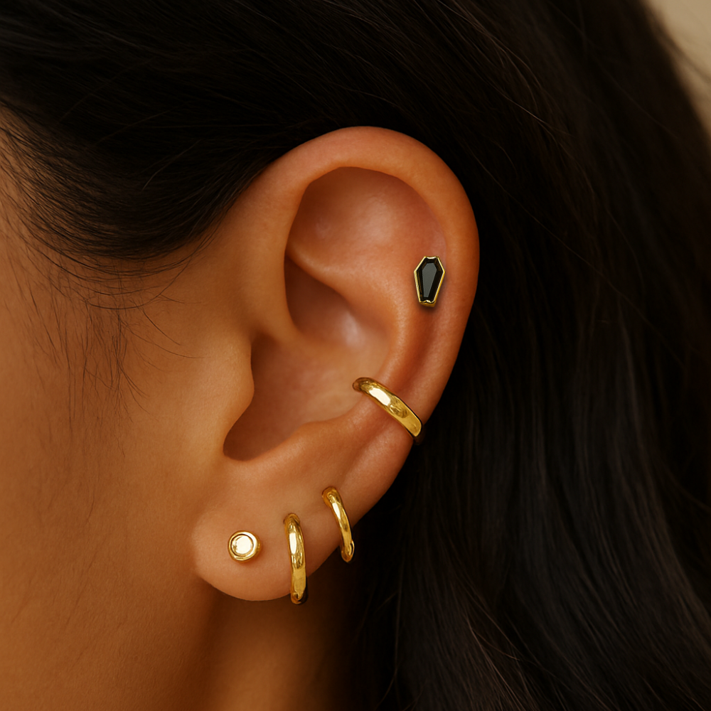 Gold CZ coffin flatback stud worn on upper ear cartilage. Stylish G23 titanium jewelry for helix or tragus piercings.